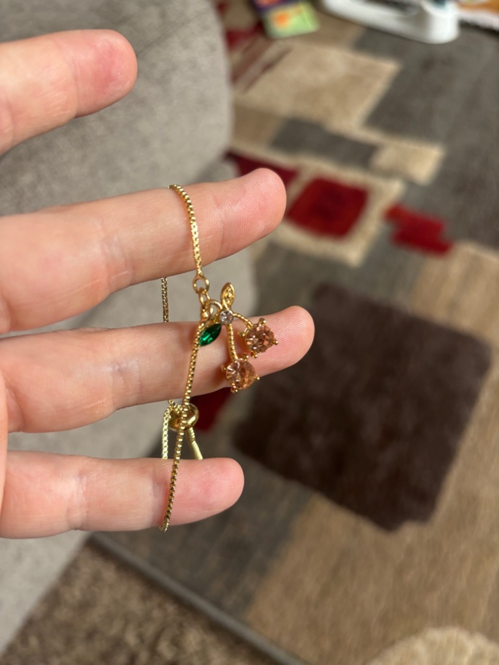 Gold-Tone Cherry Drop Bracelet with Green Leaf Accent
